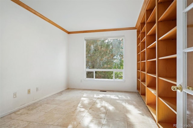 spare room with baseboards and ornamental molding