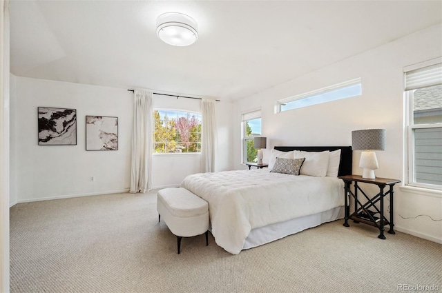 bedroom featuring carpet and baseboards
