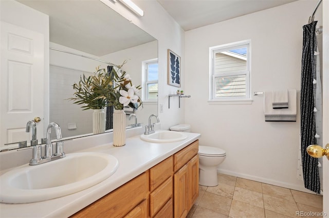 bathroom with vanity, toilet, tile patterned floors, and a shower