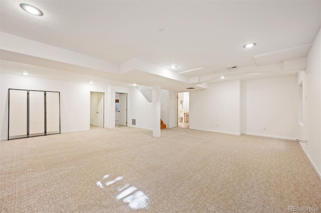 basement featuring light colored carpet