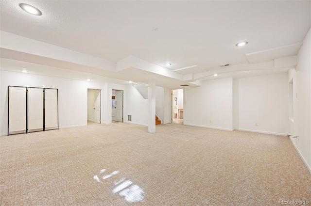 finished basement with recessed lighting, stairway, baseboards, visible vents, and light carpet