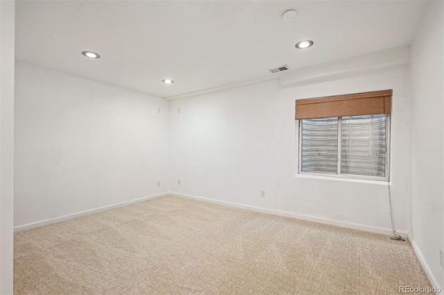 unfurnished room featuring light colored carpet