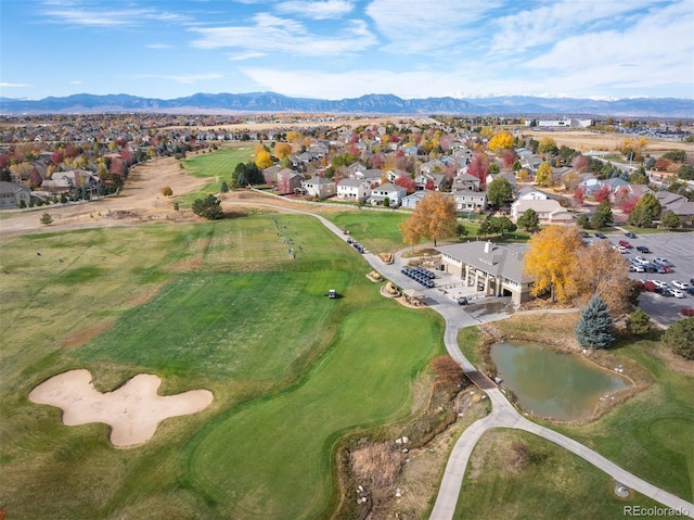 birds eye view of property featuring a water and mountain view, golf course view, and a residential view