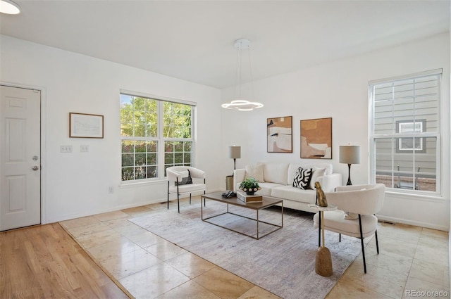 living room with baseboards and visible vents