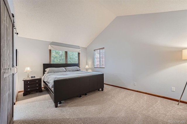 carpeted bedroom with vaulted ceiling and a textured ceiling