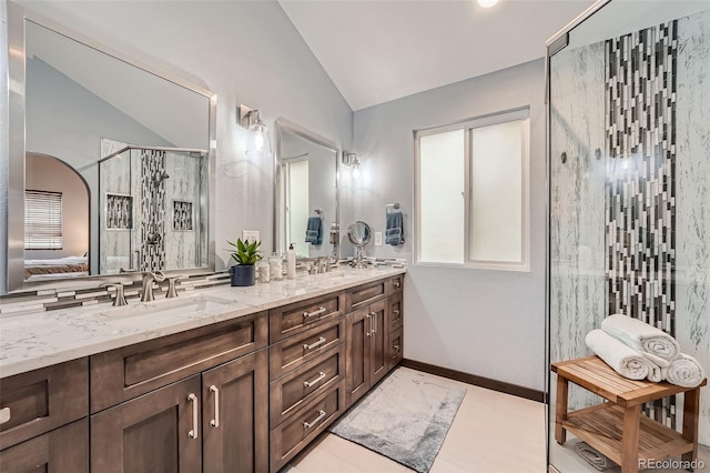 bathroom featuring tile patterned floors, a shower with door, lofted ceiling, and vanity