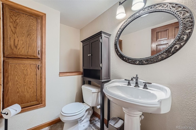 bathroom featuring toilet and sink