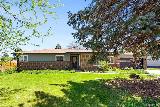 ranch-style home featuring brick siding, a front lawn, and an attached garage