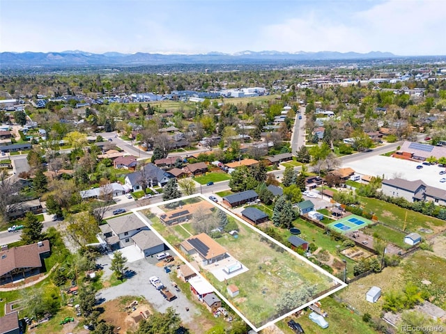 aerial view of property's location with property boundaries highlighted, a mountain backdrop, and nearby suburban area