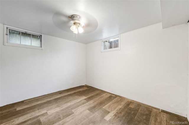basement featuring ceiling fan and wood finished floors