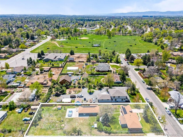 aerial perspective of suburban area with property parcel outlined and a mountain backdrop