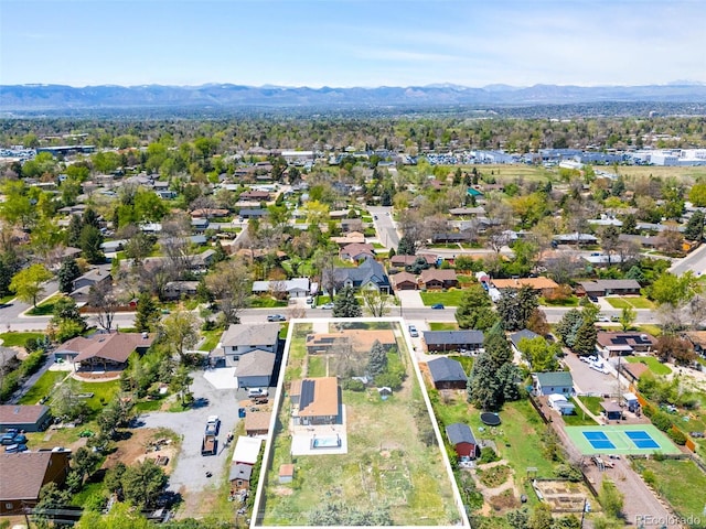 aerial view of property and surrounding area featuring mountains, nearby suburban area, and property boundaries highlighted