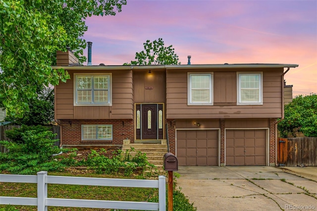 9832 High St, Thornton, CO 80229 - raised ranch with an attached garage, concrete driveway, and brick siding