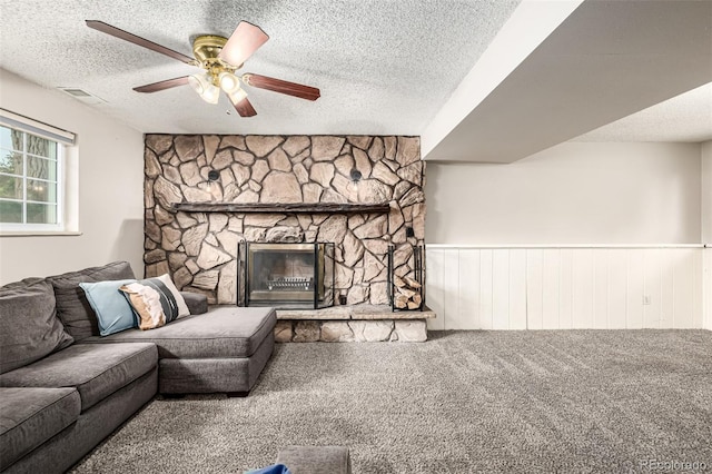 9832 High St, Thornton, CO 80229 - living room with a textured ceiling, a ceiling fan, carpet flooring, a wainscoted wall, and a fireplace