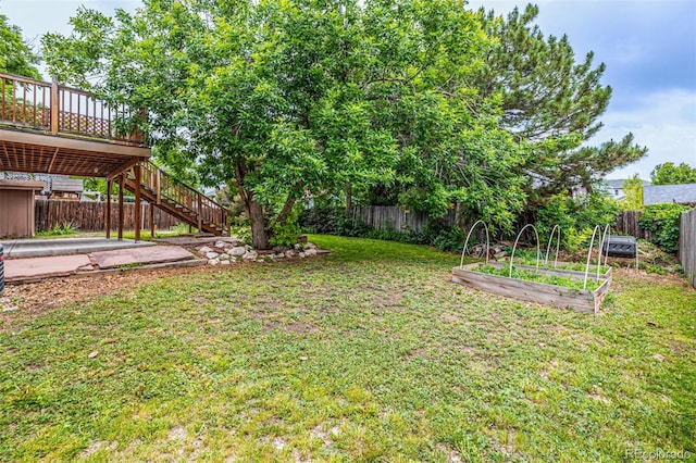 9832 High St, Thornton, CO 80229 - view of yard with a vegetable garden, stairs, and a deck
