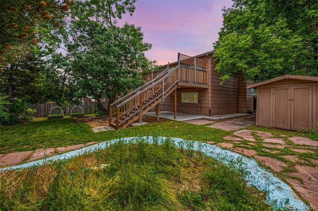 9832 High St, Thornton, CO 80229 - yard at dusk featuring a patio area, stairs, and a deck