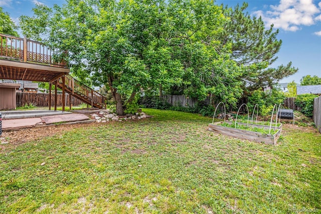 9832 High St, Thornton, CO 80229 - view of yard with a vegetable garden, stairs, and a wooden deck