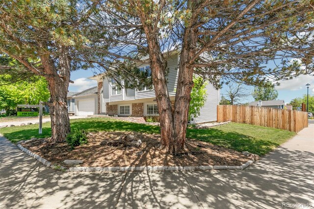 5886 S Nepal Way, Centennial, CO 80015 - tri-level home featuring an attached garage