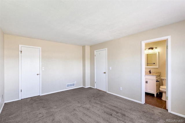 5886 S Nepal Way, Centennial, CO 80015 - unfurnished bedroom with dark carpet, baseboards, and ensuite bath