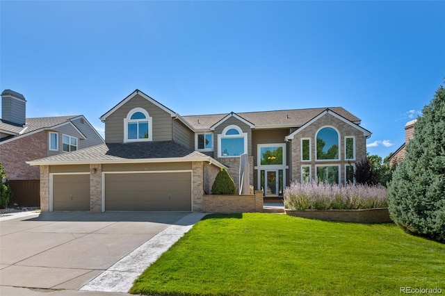 front of property featuring a front yard and a garage