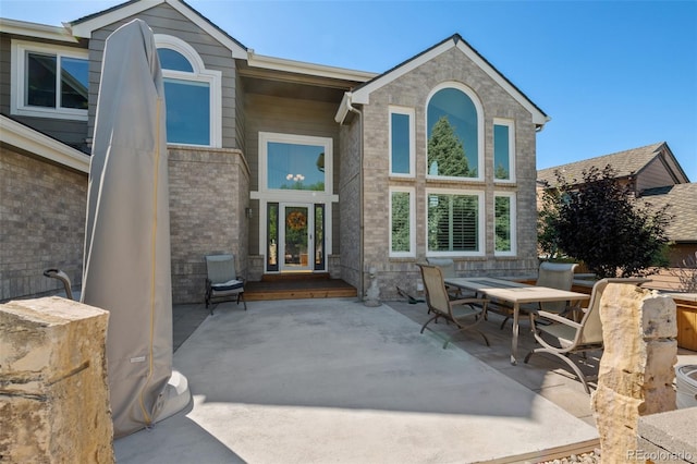 rear view of property featuring french doors and a patio area