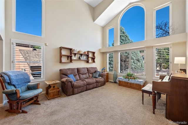 living room with a towering ceiling and carpet