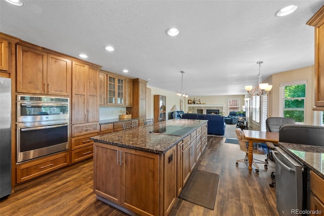 kitchen featuring stainless steel appliances, a chandelier, dark hardwood / wood-style floors, and a kitchen island