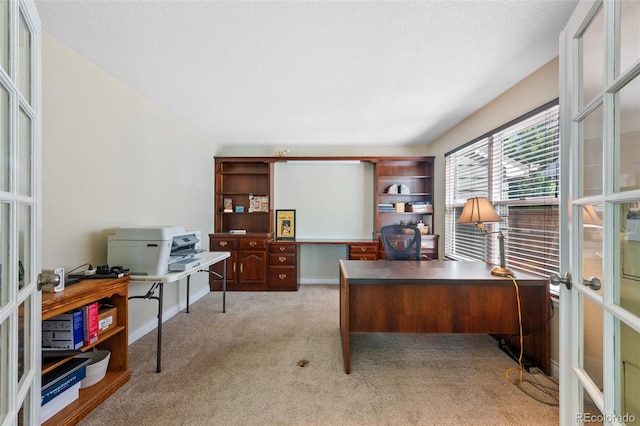 office area with light carpet, a textured ceiling, and french doors