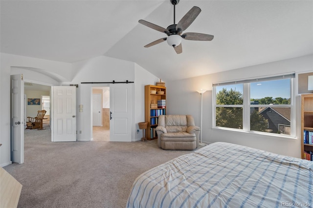 bedroom with light carpet, lofted ceiling, ceiling fan, and a barn door