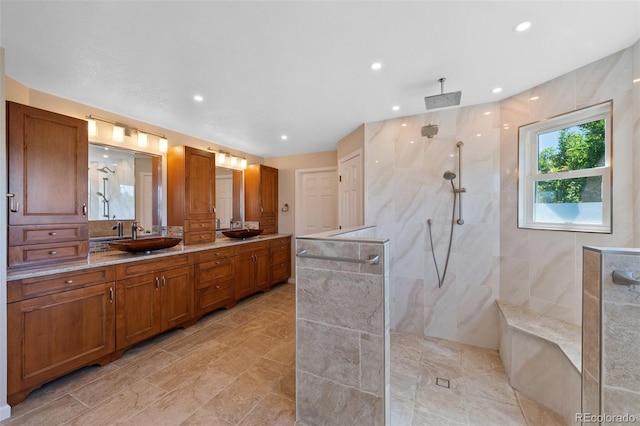 bathroom featuring vanity and tiled shower