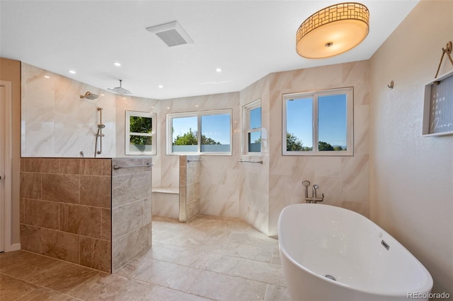 bathroom with ceiling fan, separate shower and tub, and tile walls