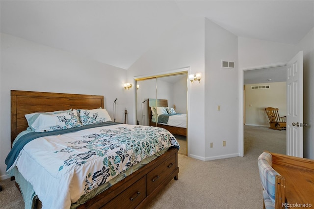 carpeted bedroom featuring a closet and high vaulted ceiling