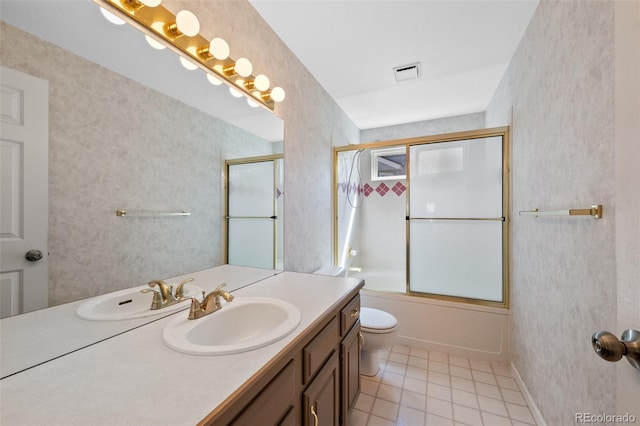 full bathroom with toilet, vanity, and combined bath / shower with glass door