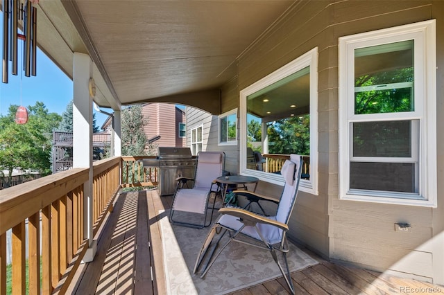 wooden deck with a grill