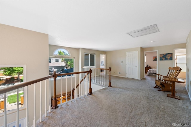 hall with light colored carpet