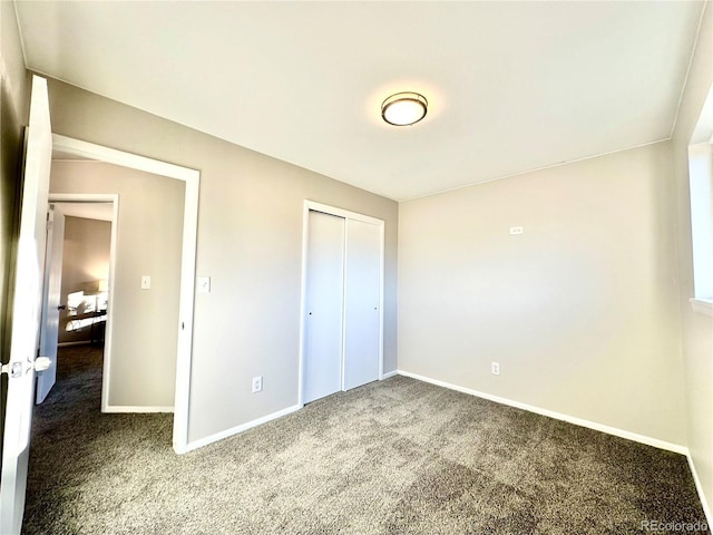 unfurnished bedroom with carpet and a closet