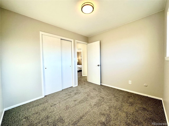 unfurnished bedroom featuring carpet floors and a closet