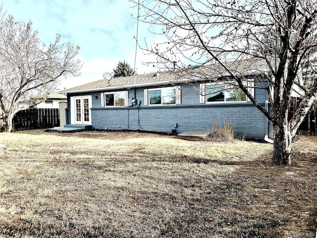 view of front of house featuring a front yard and french doors