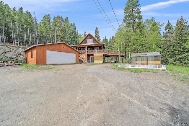 80 Castlewood Ct, Evergreen, CO 80439 - view of front of property with stairway, an outdoor structure, a garage, and a greenhouse