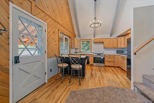 80 Castlewood Ct, Evergreen, CO 80439 - kitchen featuring appliances with stainless steel finishes, light wood finished floors, a chandelier, decorative backsplash, and healthy amount of natural light