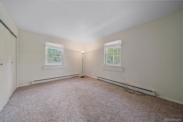80 Castlewood Ct, Evergreen, CO 80439 - unfurnished bedroom with baseboard heating, multiple windows, and carpet floors