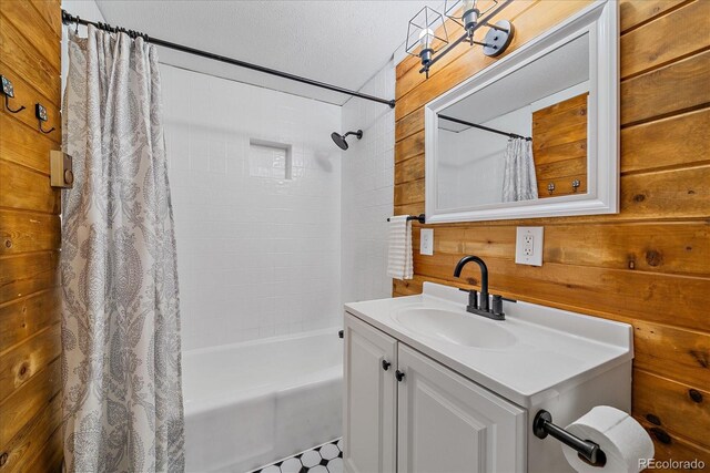 80 Castlewood Ct, Evergreen, CO 80439 - bathroom with shower / bath combo with shower curtain, vanity, wood walls, and a textured ceiling