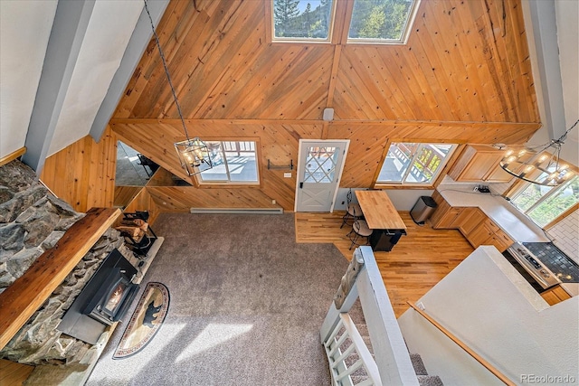 80 Castlewood Ct, Evergreen, CO 80439 - unfurnished living room with wood walls, a towering ceiling, wood finished floors, and carpet flooring