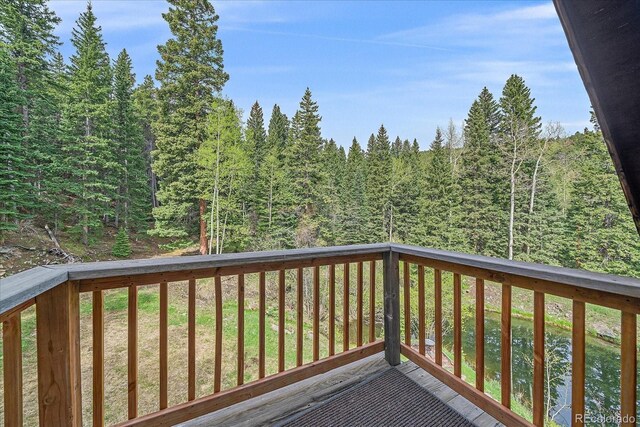 80 Castlewood Ct, Evergreen, CO 80439 - wooden deck with a forest view