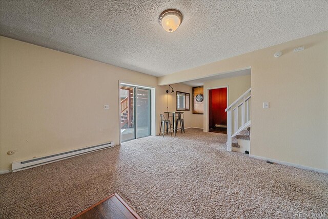 80 Castlewood Ct, Evergreen, CO 80439 - carpeted spare room featuring a baseboard radiator, stairway, and a textured ceiling