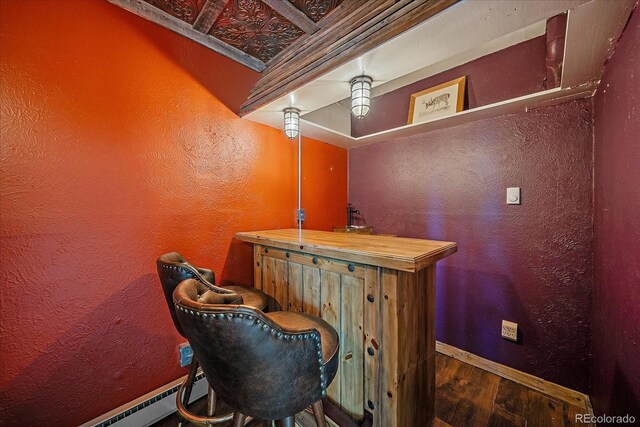 80 Castlewood Ct, Evergreen, CO 80439 - indoor dry bar featuring wood finished floors, a textured wall, baseboards, and a baseboard radiator