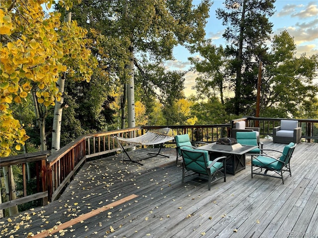 80 Castlewood Ct, Evergreen, CO 80439 - wooden terrace with view of wooded area and an outdoor living space with a fire pit