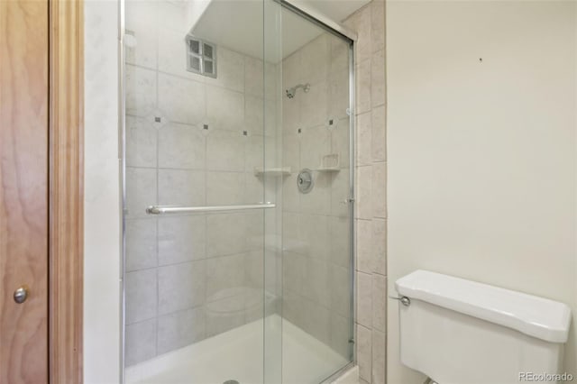 625 S Clinton St Unit 7A, Denver, CO 80247 - bathroom featuring toilet and a shower stall