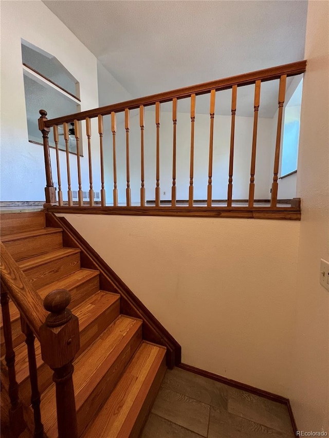 staircase featuring hardwood / wood-style flooring and a healthy amount of sunlight