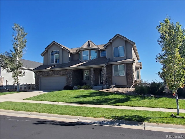 view of front of property featuring a garage and a front yard